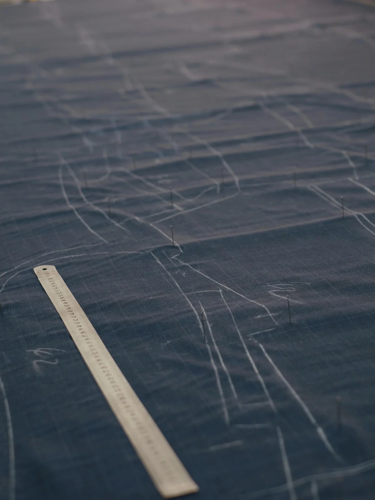 Garment pattern outlines marked on fabric before cutting.
